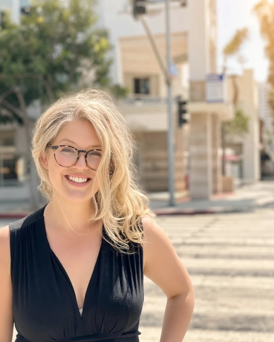 Anna Berglund, LA hairstylist and colorist, smiling outdoors on a sunny Santa Monica street.