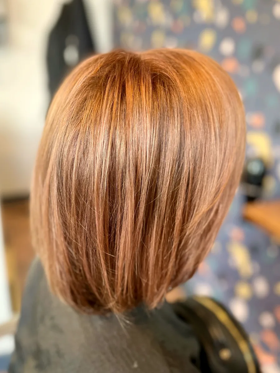 Glossy copper bob, precision cut and finished smooth — back view.