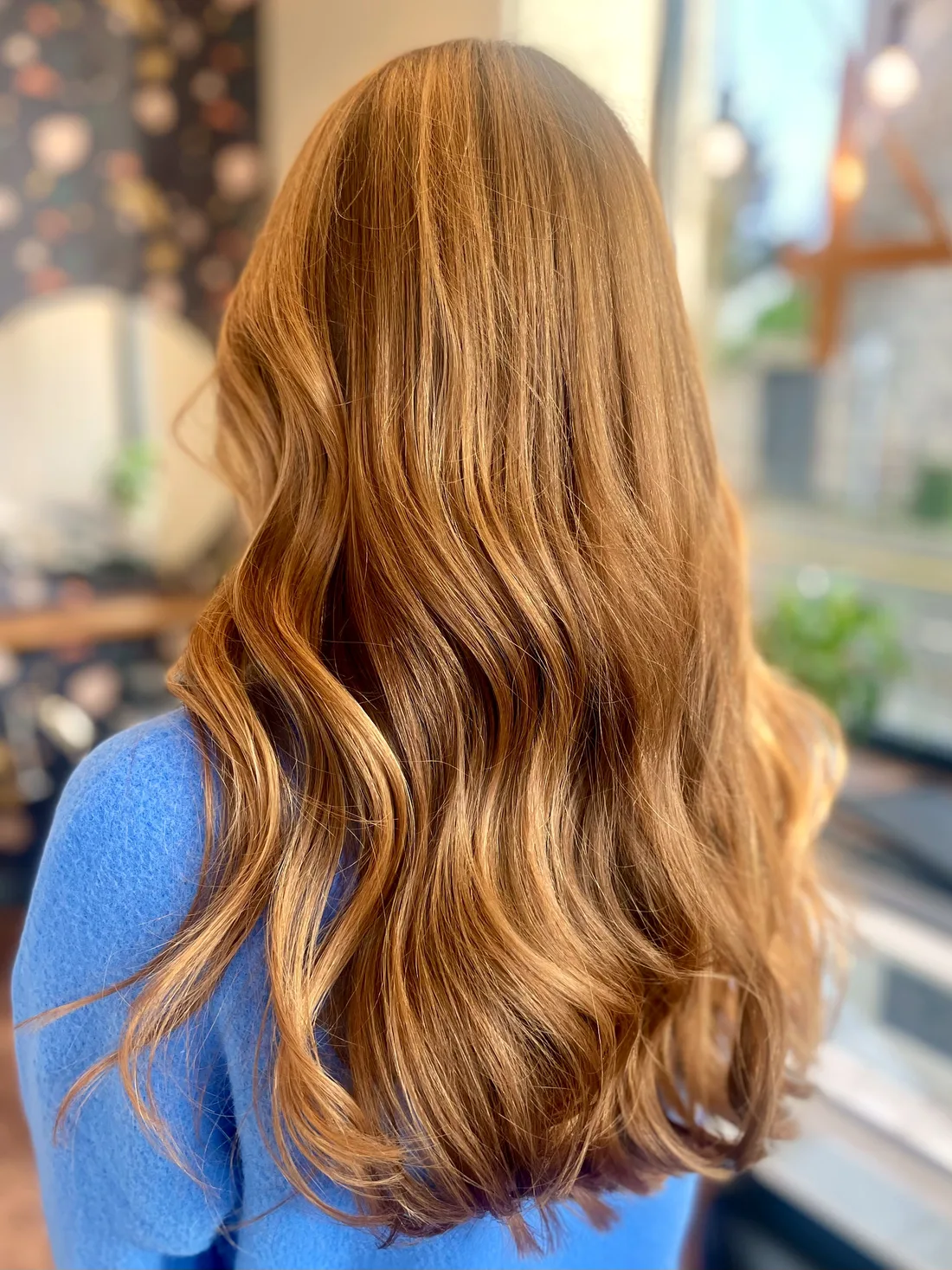 Long copper-blonde hair in glossy, soft waves — vibrant dimensional color by Anna Berglund.